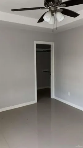 a view of a room with a ceiling fan