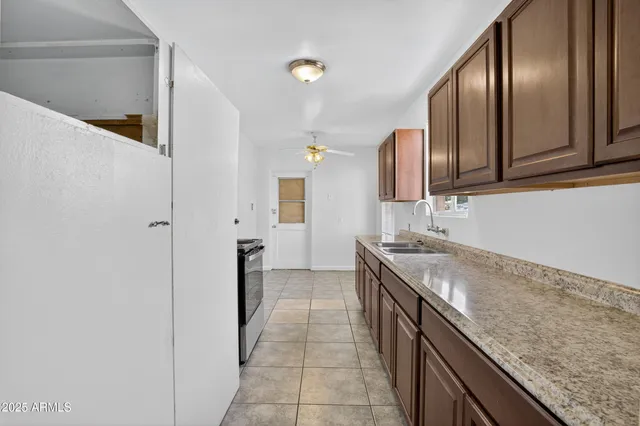 a kitchen with granite countertop a sink and cabinets