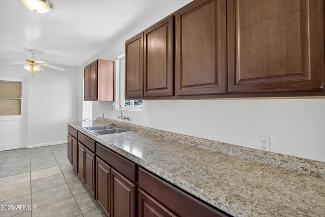a kitchen with a stove sink and cabinets