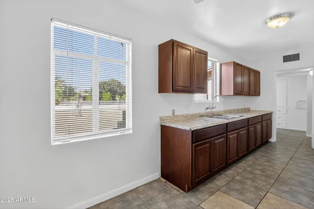 a view of a kitchen with refrigerator and an oven