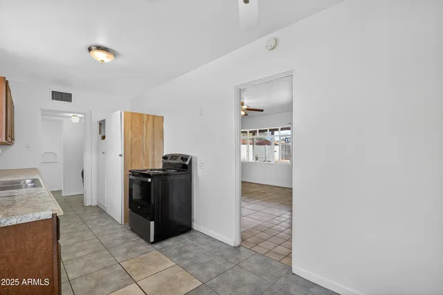 a kitchen with a refrigerator and a stove