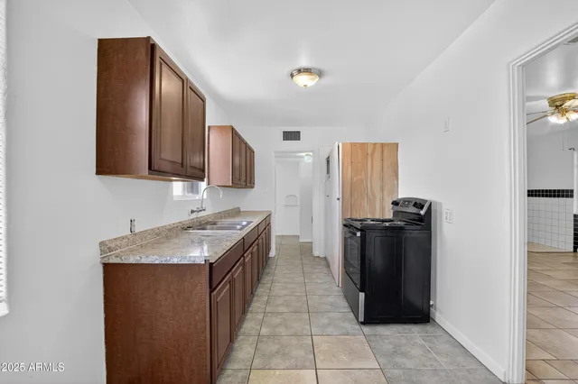 a kitchen with granite countertop stainless steel appliances and wooden cabinets