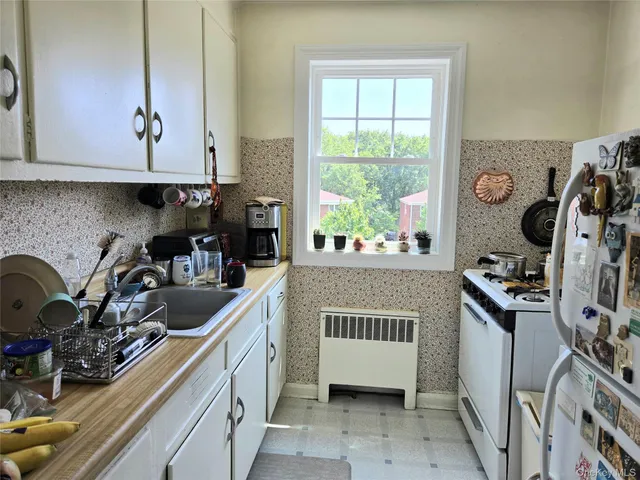 a kitchen with a stove a sink and a microwave