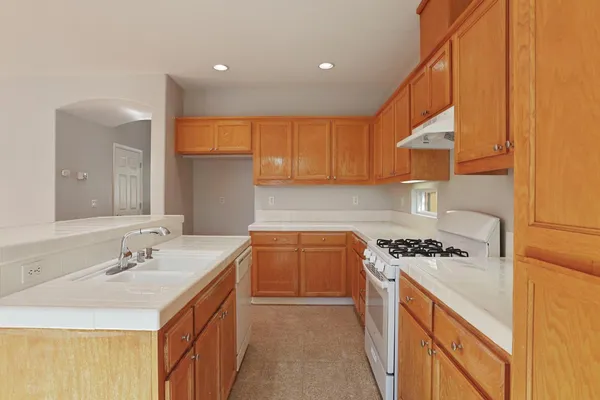a kitchen that has a sink and a stove