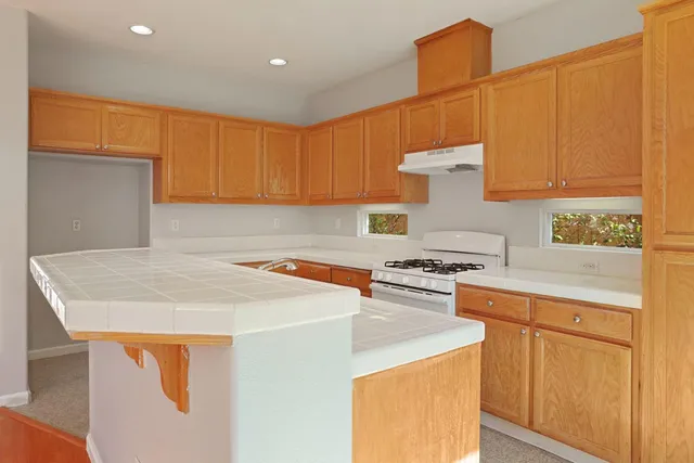 a kitchen with a sink a stove and a microwave