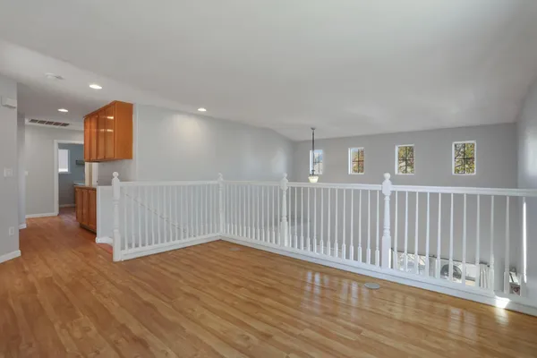 a view of a hallway with wooden floor