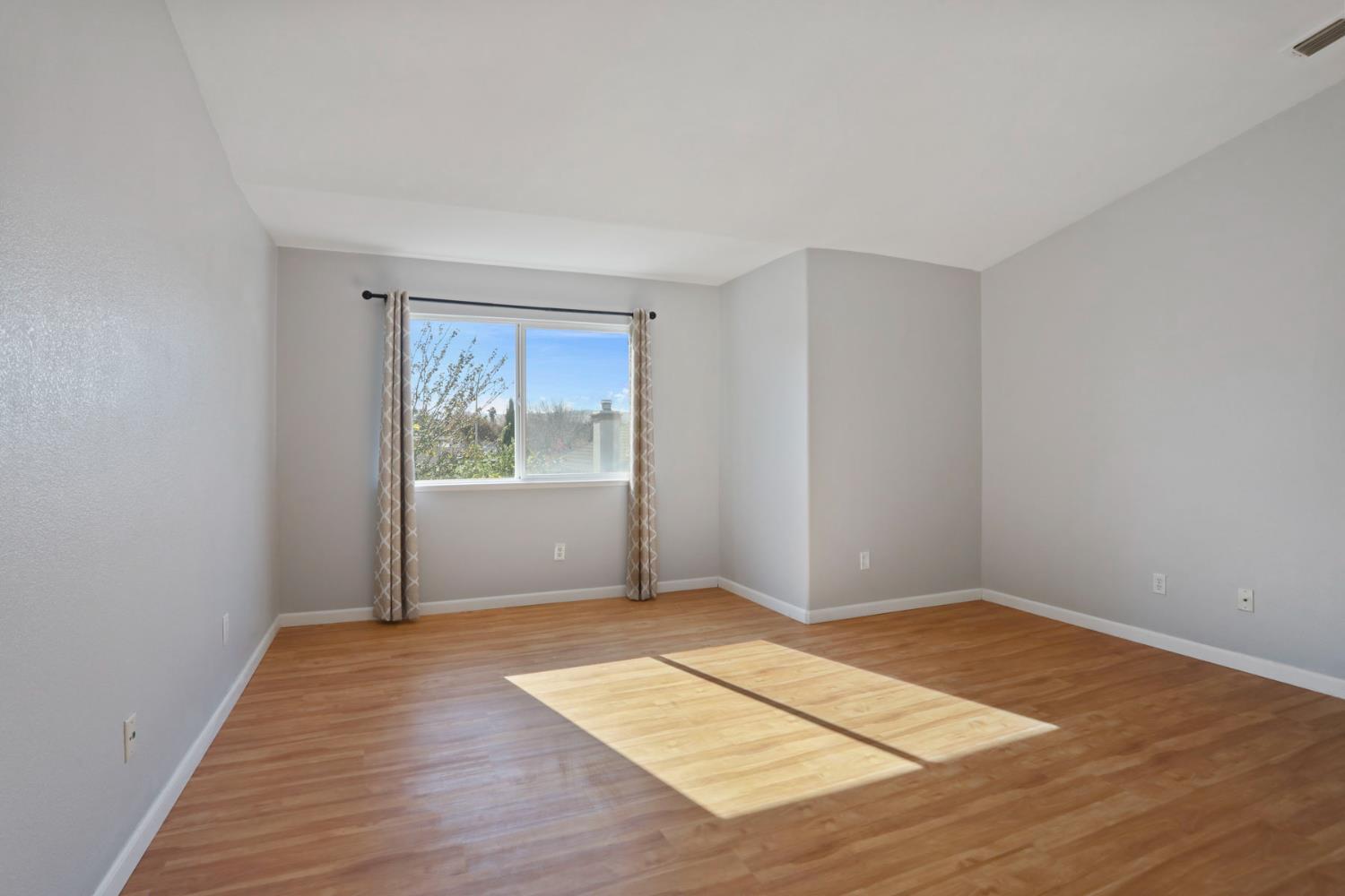 2902 Campbell Lane Tracy, CA 95377 - Photo 19 of 29 an empty room with wooden floor and windows