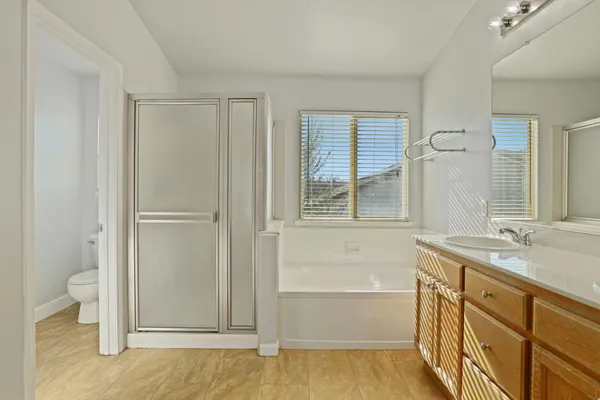 a bathroom with a tub sink and toilet
