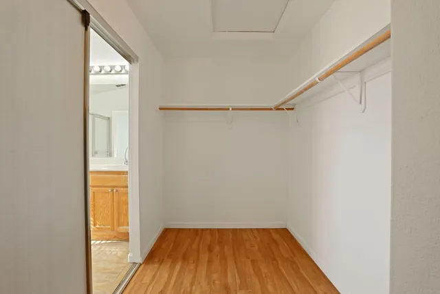 a view of a small space with wooden floor and a window