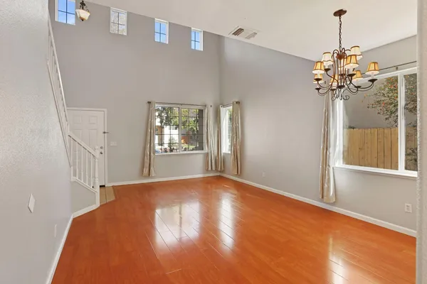a view of a bedroom with a chandelier and wooden floor