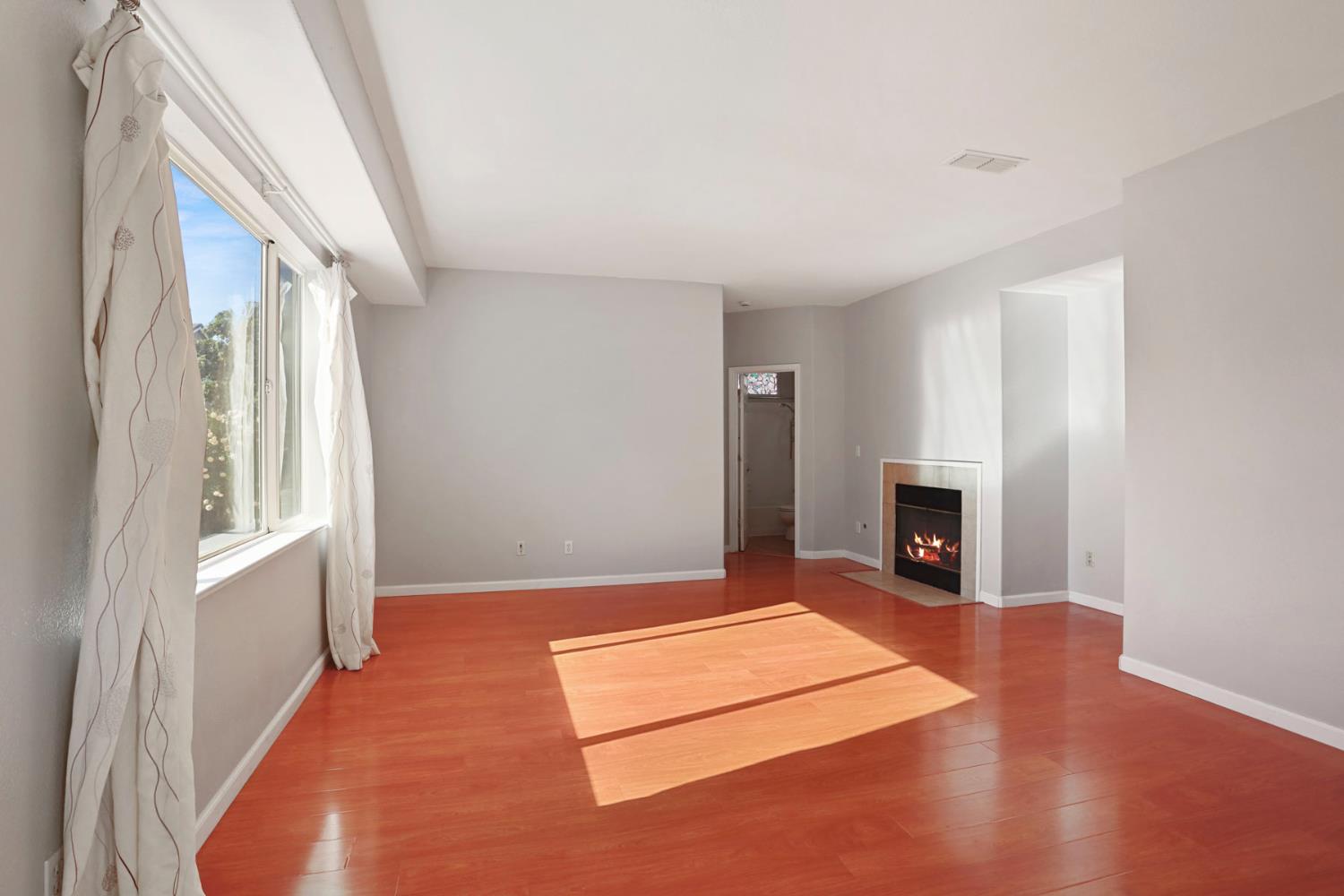 2902 Campbell Lane Tracy, CA 95377 - Photo 10 of 29 a view of an empty room with a fireplace and a window