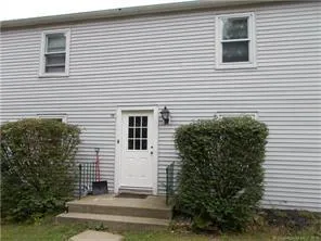 a view of a house with a yard and a garage