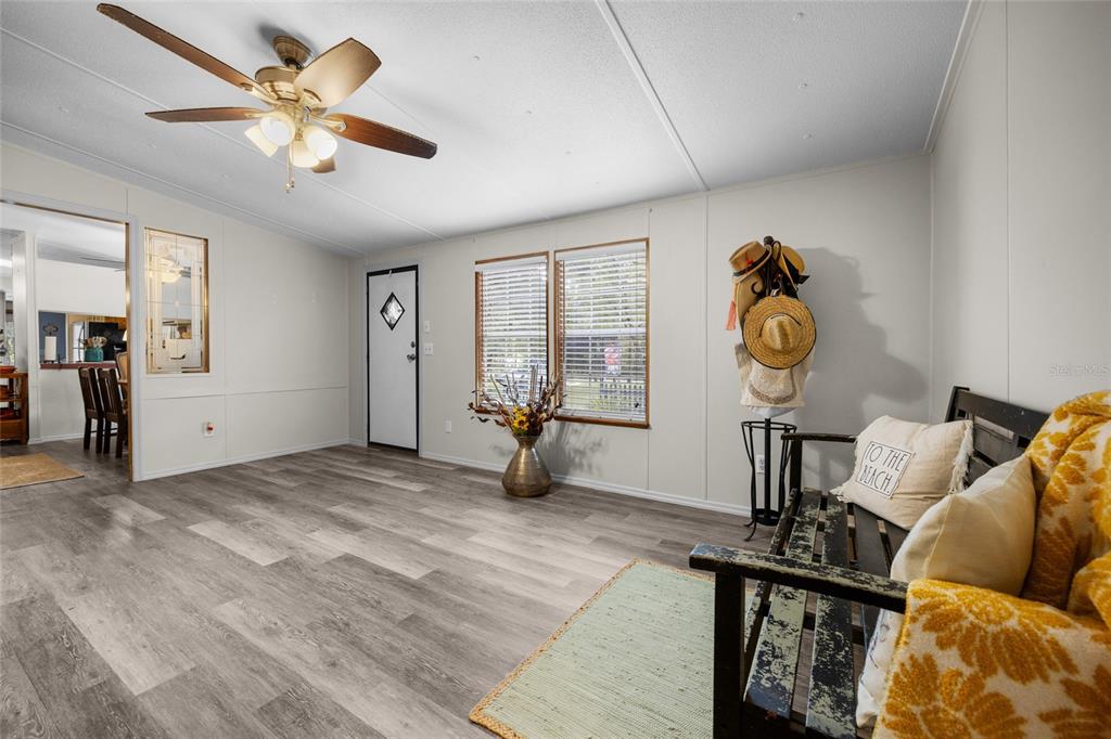 3639 Northeast 80th Avenue High Springs, FL 32643 - Photo 11 of 35 a view of a livingroom with furniture hardwood floor a ceiling fan and windows