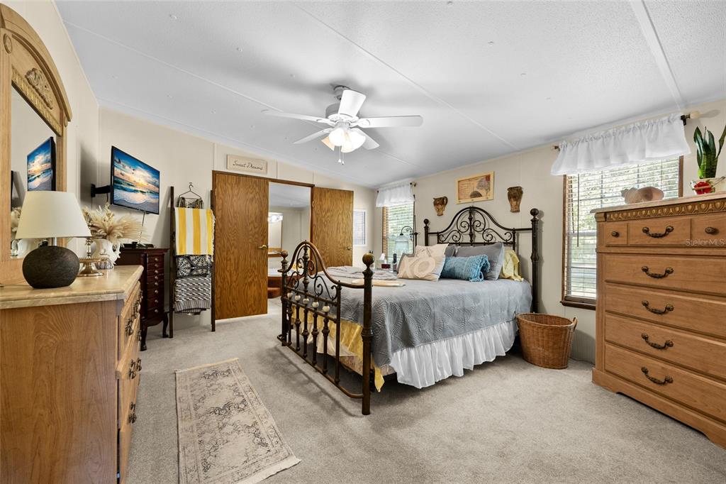 3639 Northeast 80th Avenue High Springs, FL 32643 - Photo 13 of 35 a bed room with a bed and a ceiling fan