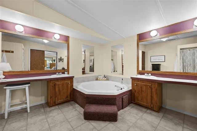 a large bathroom with a large tub and sink