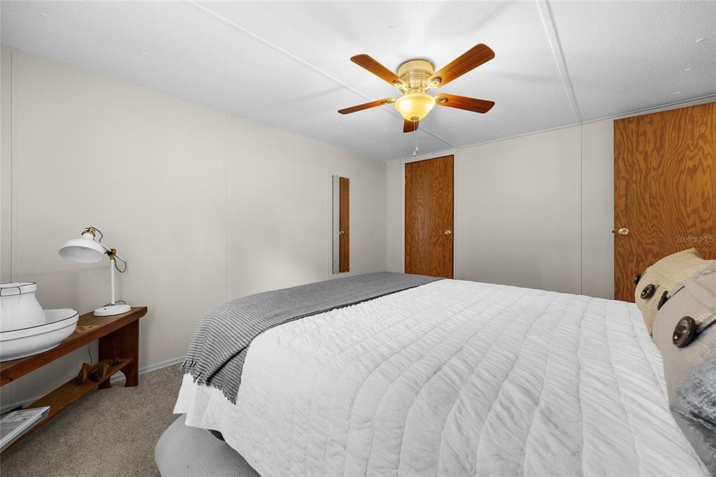 3639 Northeast 80th Avenue High Springs, FL 32643 - Photo 19 of 35 a bedroom with a bed and a chandelier