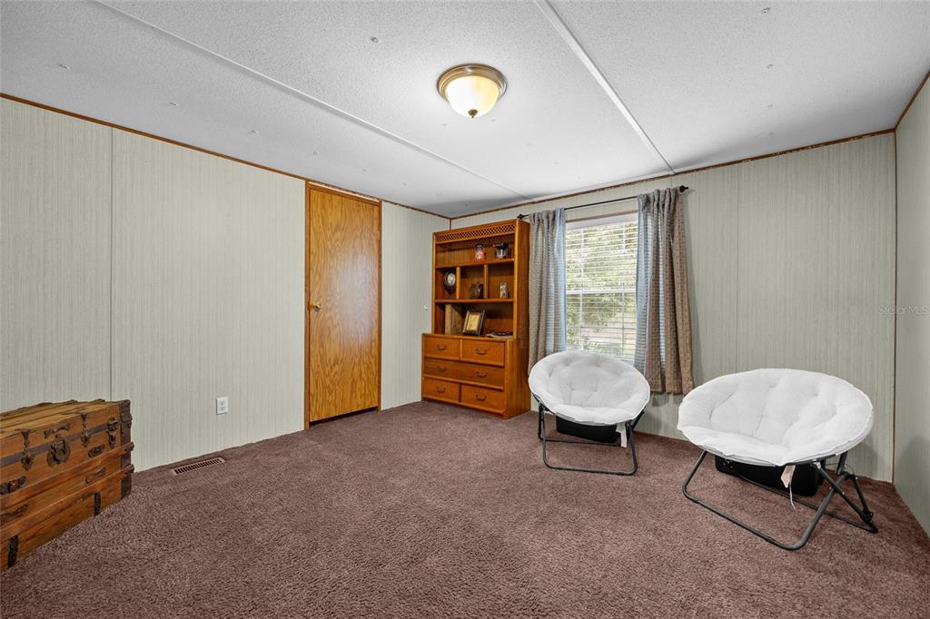 3639 Northeast 80th Avenue High Springs, FL 32643 - Photo 21 of 35 a view of a room with wooden floor and furniture