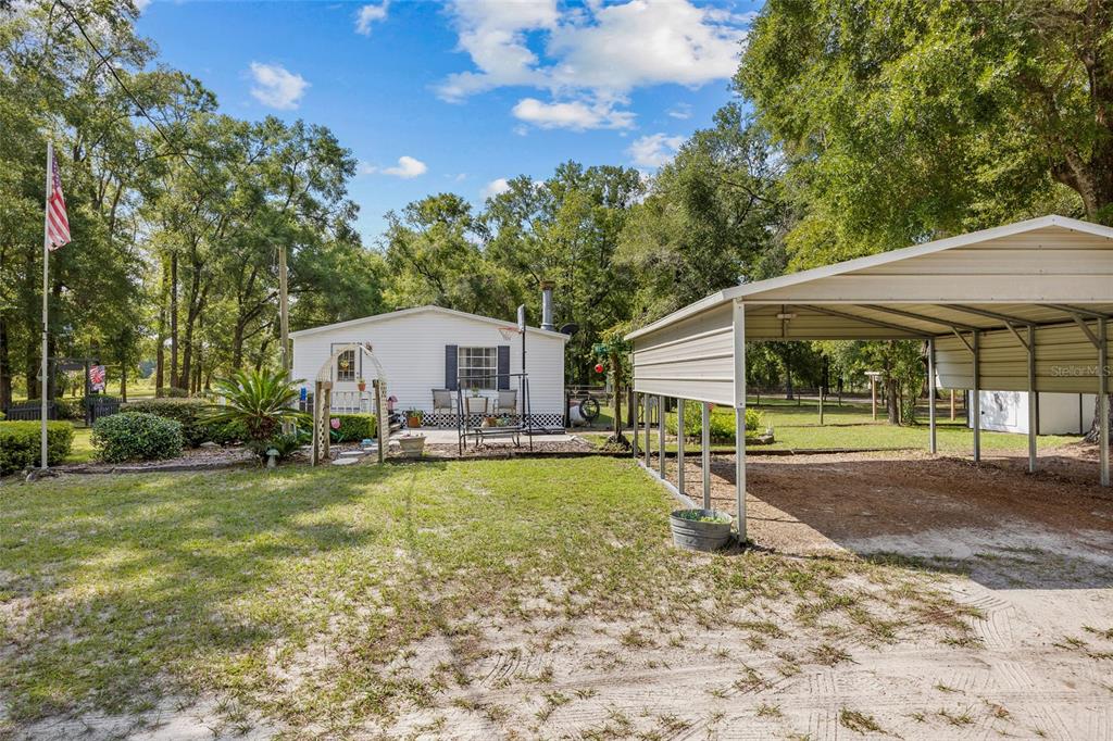 3639 Northeast 80th Avenue High Springs, FL 32643 - Photo 24 of 35 a view of a house with swimming pool and sitting area