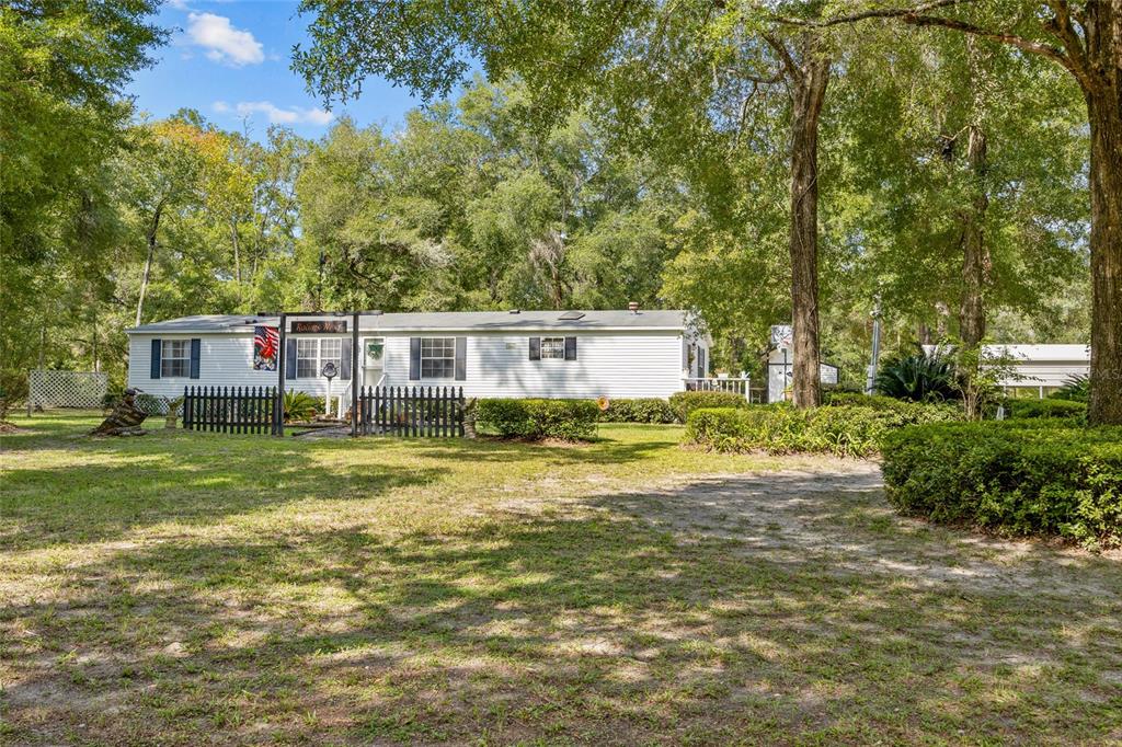 3639 Northeast 80th Avenue High Springs, FL 32643 - Photo 27 of 35 a view of a house next to a big yard and large trees