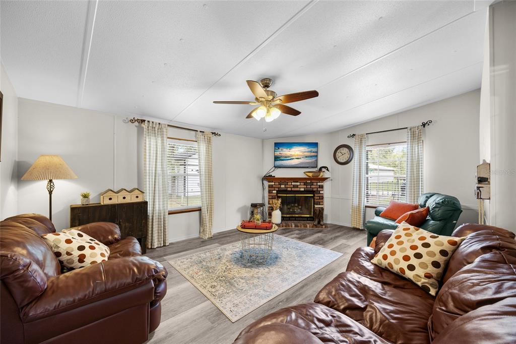 3639 Northeast 80th Avenue High Springs, FL 32643 - Photo 3 of 35 a living room with furniture a fireplace and a flat screen tv