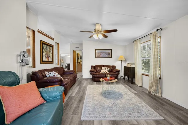 a living room with furniture fireplace and a window