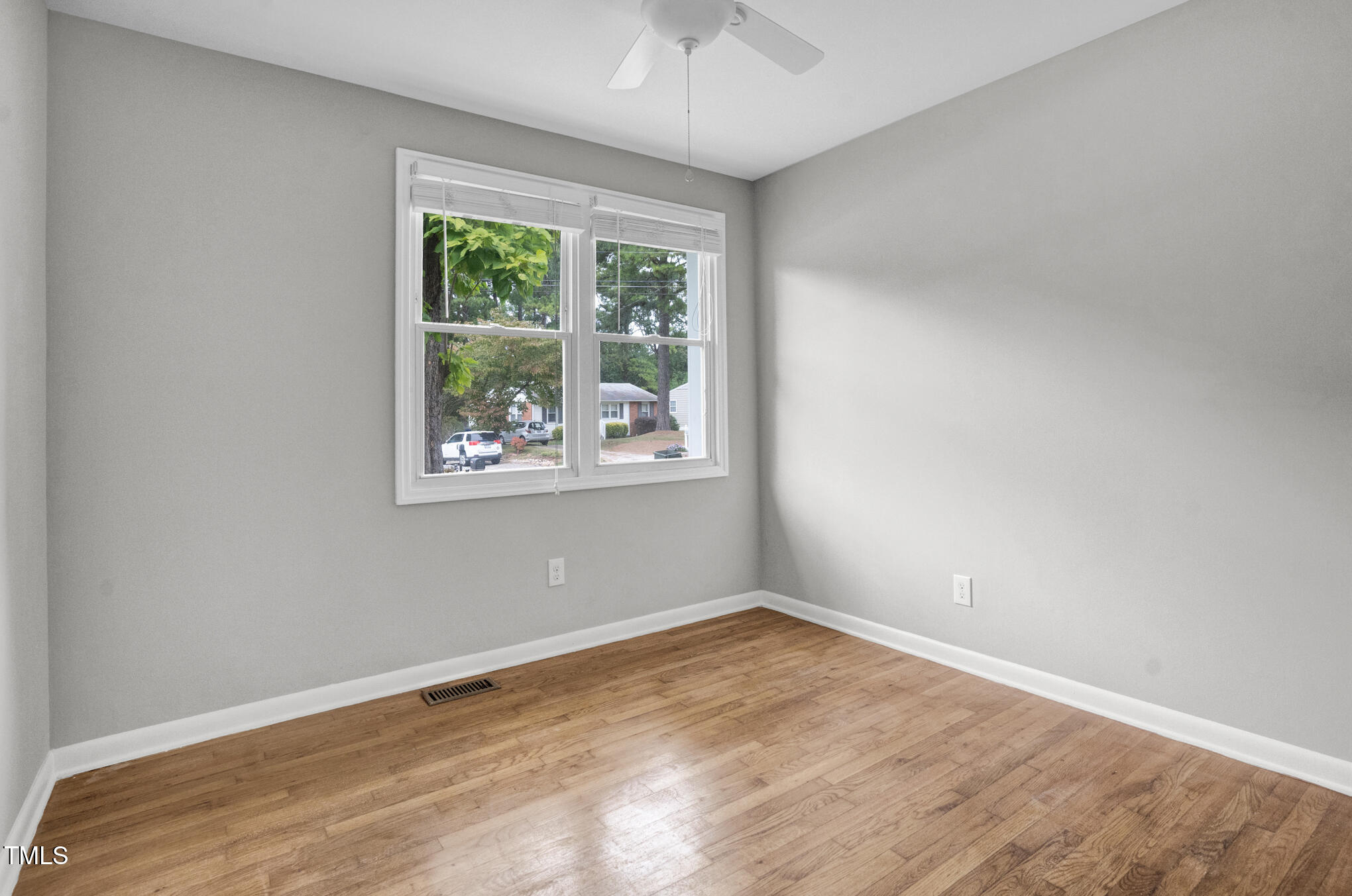 3312 Apache Drive Raleigh, NC 27609 - Photo 11 of 12 an empty room with wooden floor and windows
