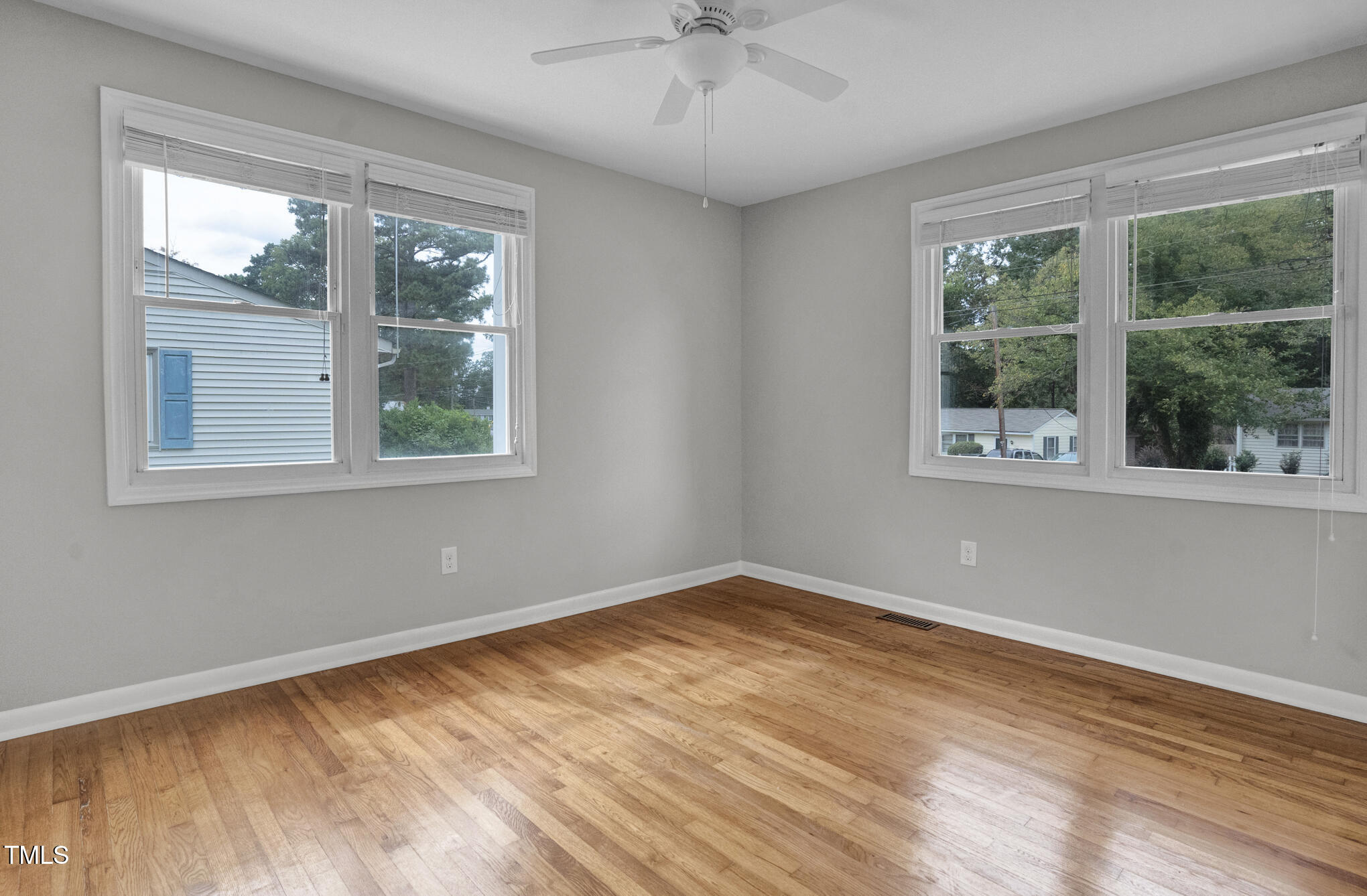 3312 Apache Drive Raleigh, NC 27609 - Photo 12 of 12 a view of an empty room with wooden floor and a window