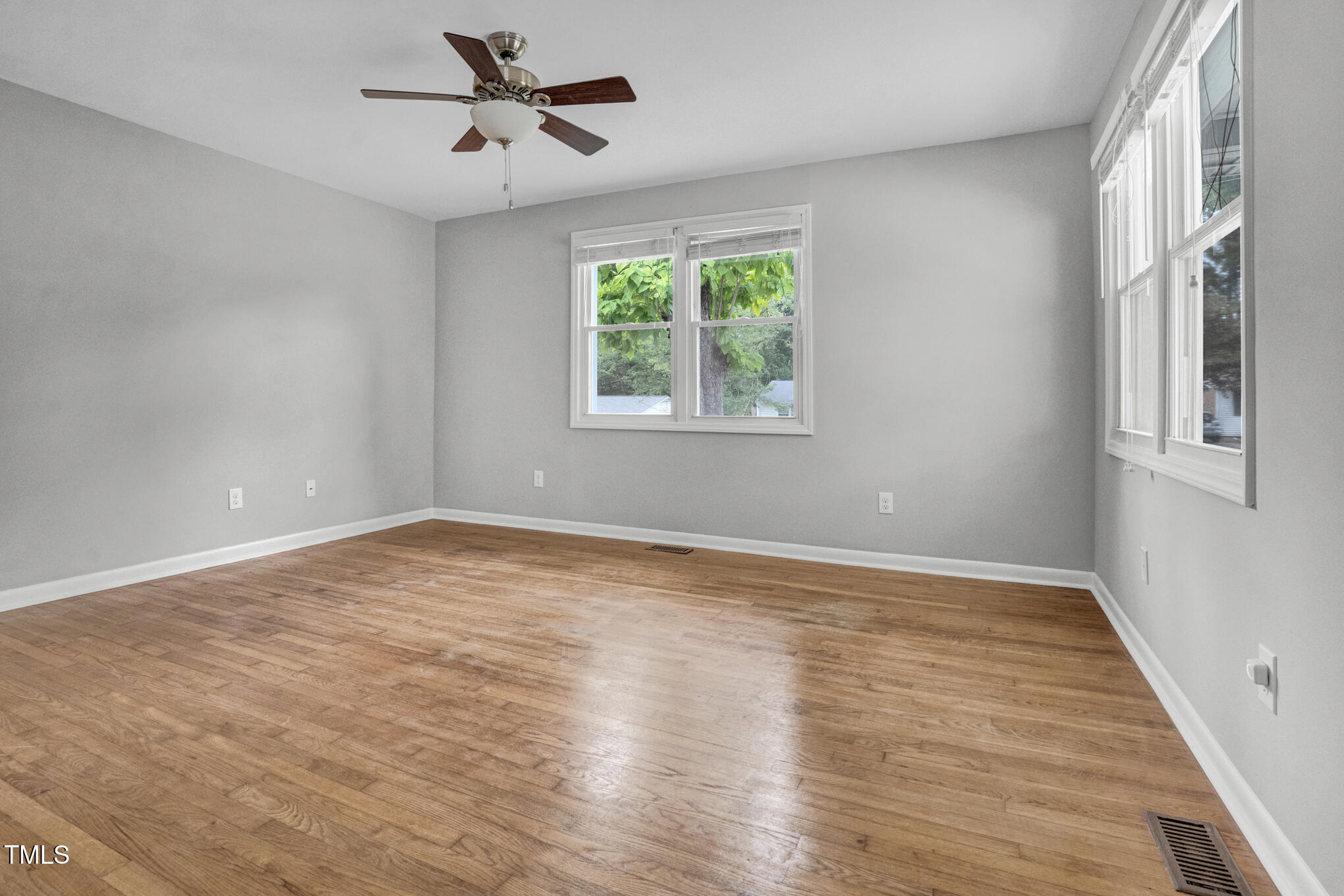 3312 Apache Drive Raleigh, NC 27609 - Photo 6 of 12 wooden floor in an empty room with a window