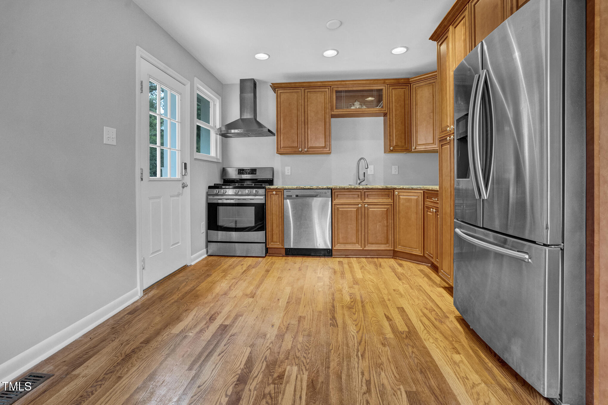 3312 Apache Drive Raleigh, NC 27609 - Photo 7 of 12 a kitchen with stainless steel appliances granite countertop a refrigerator microwave and stove