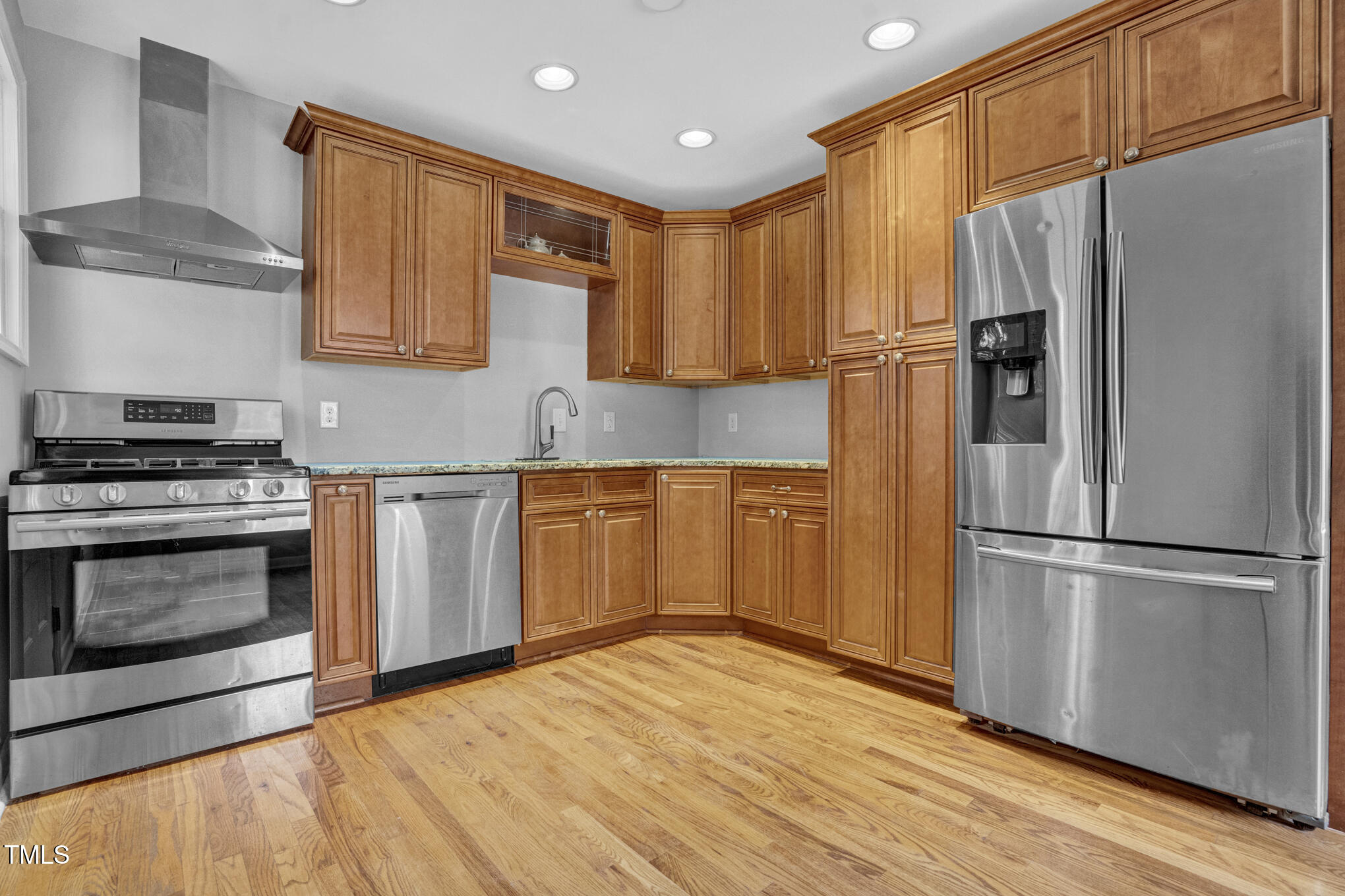 3312 Apache Drive Raleigh, NC 27609 - Photo 8 of 12 a kitchen with granite countertop a refrigerator stove and microwave