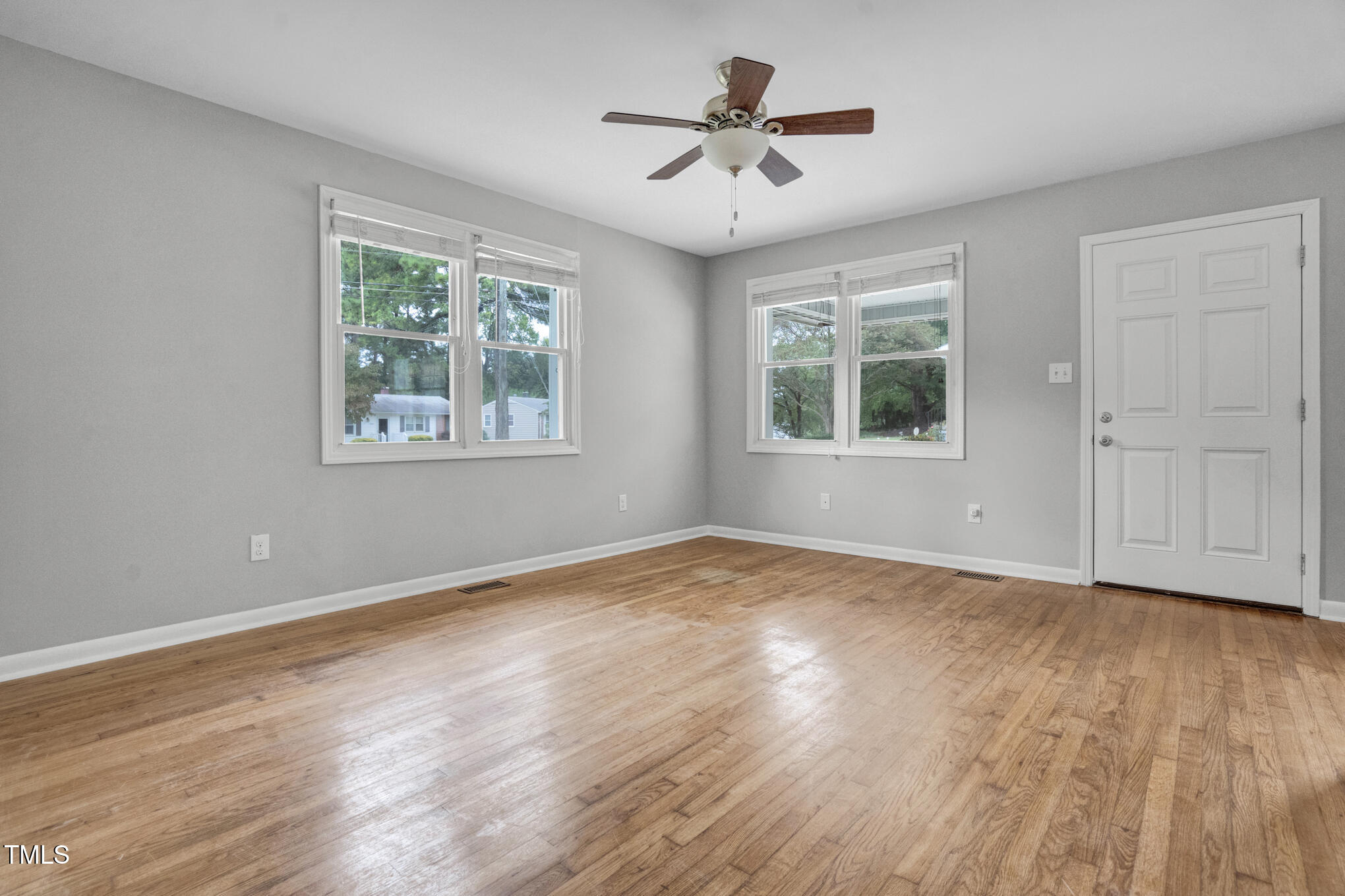 3312 Apache Drive Raleigh, NC 27609 - Photo 9 of 12 a view of an empty room with a window and wooden floor