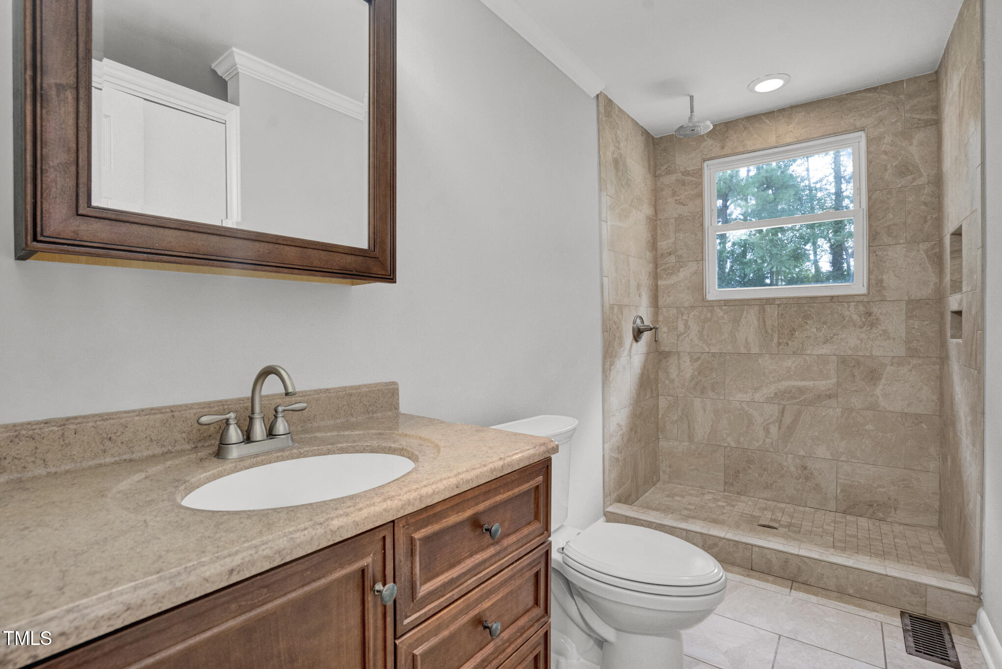 3312 Apache Drive Raleigh, NC 27609 - Photo 10 of 12 a bathroom with a granite countertop sink toilet and shower