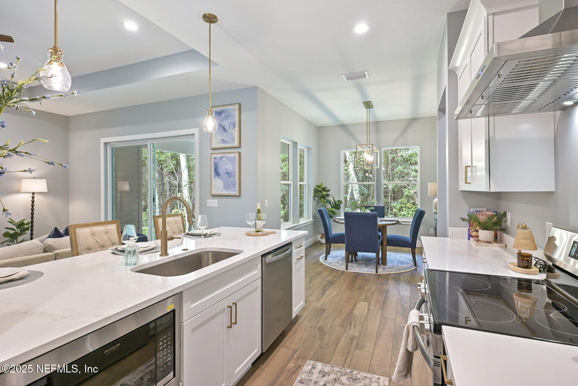 4435 Julington Creek Road Jacksonville, FL 32258 - Photo 14 of 64 a kitchen with sink stove dining table and chairs