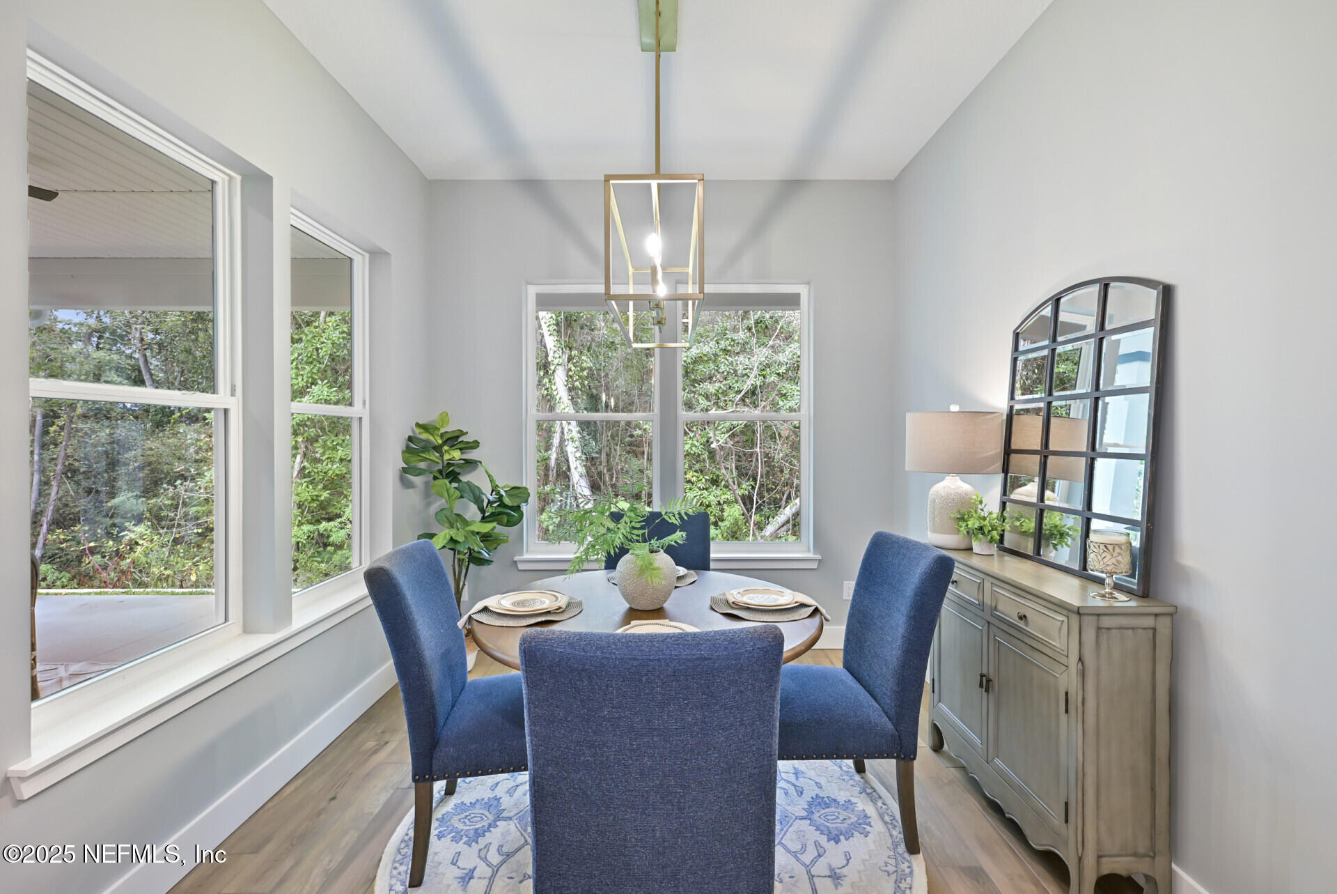 4435 Julington Creek Road Jacksonville, FL 32258 - Photo 18 of 64 a dining room with furniture a chandelier and wooden floor