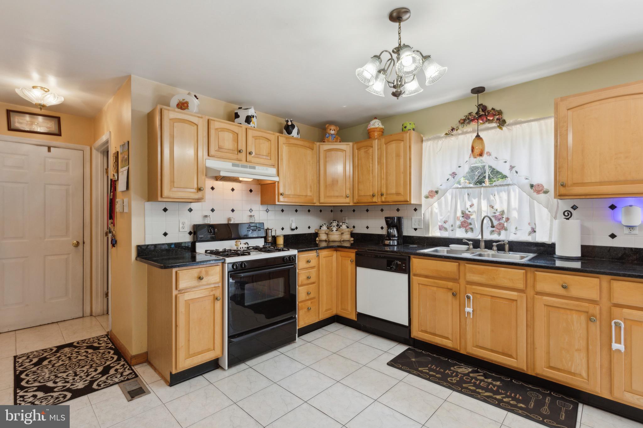 38 Cherry Tree Court Spring City, PA 19475 - Photo 6 of 35 a kitchen with stainless steel appliances granite countertop a stove a sink and a refrigerator
