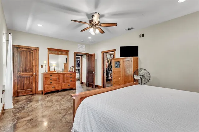 a bedroom with a bed and a television