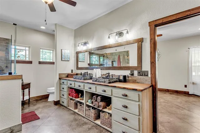 a bathroom with double vanity and a mirror