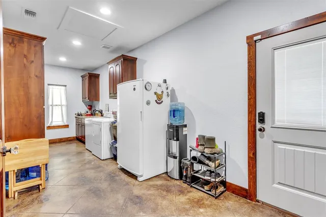 a view of a hallway with washer and dryer