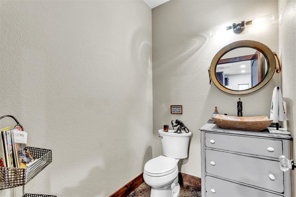 337 County Road 3535 Saltillo, TX 75478 - Photo 27 of 36 a bathroom with a toilet a sink and mirror