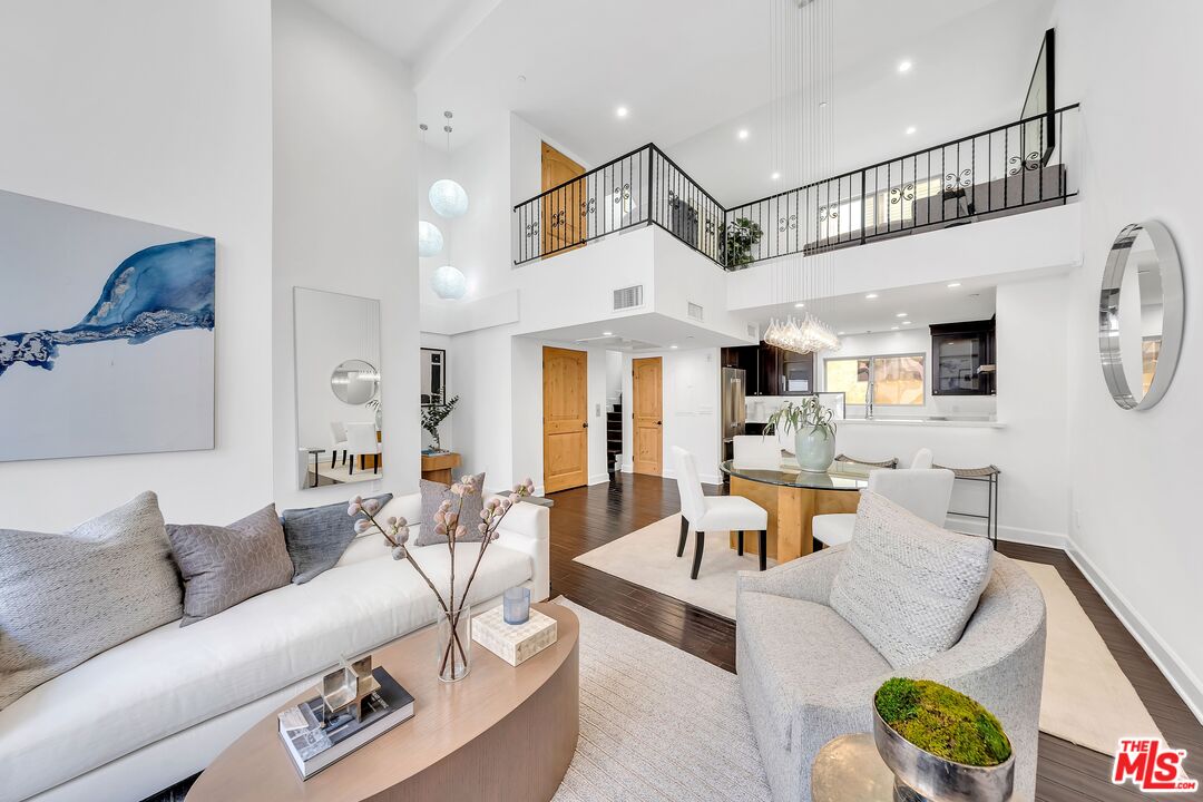 108 South Wetherly Drive, Unit 2 Los Angeles, CA 90048 - Photo 1 of 2 a living room with furniture and a chandelier