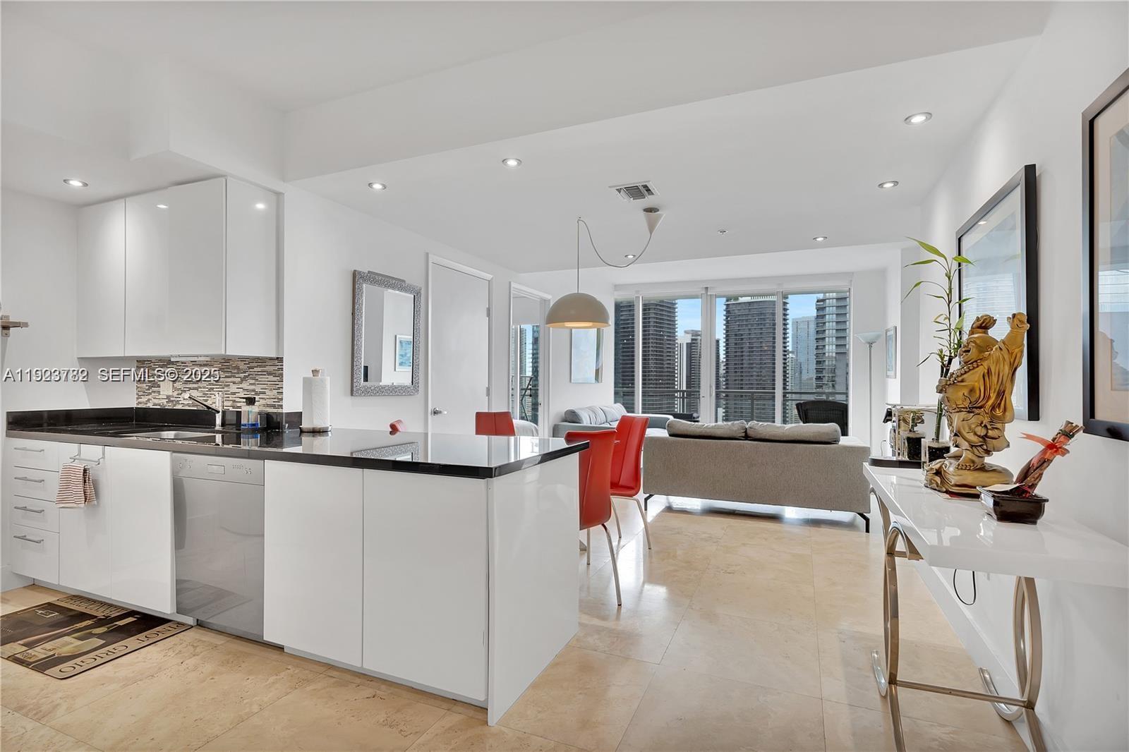 a large white kitchen with a large window
