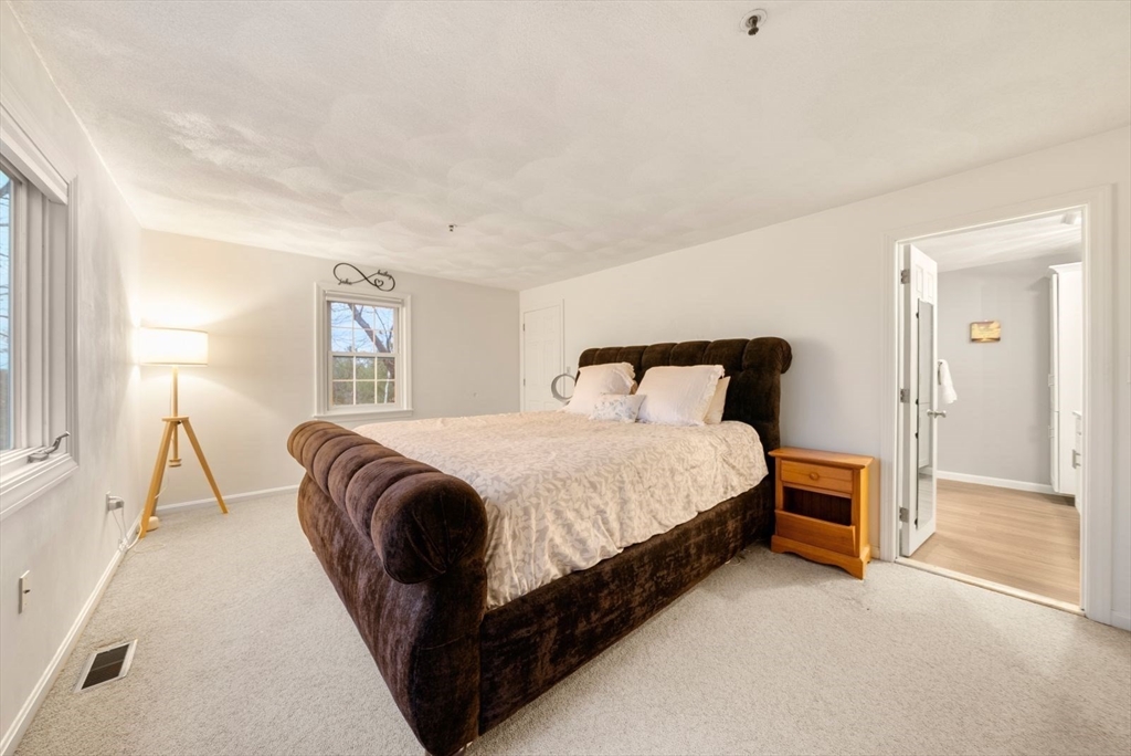 5 Oak Ridge Drive, Unit 7 Maynard, MA 01754 - Photo 11 of 20 a bedroom with a bed lamp closet and window