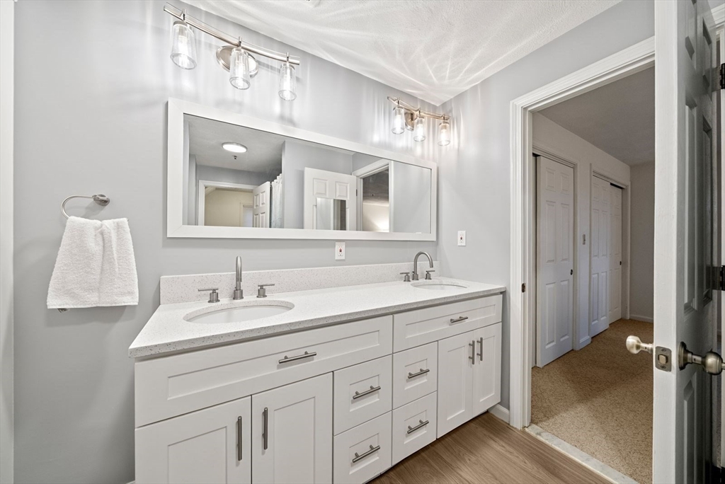 5 Oak Ridge Drive, Unit 7 Maynard, MA 01754 - Photo 12 of 20 a spacious bathroom with a double vanity sink and a mirror