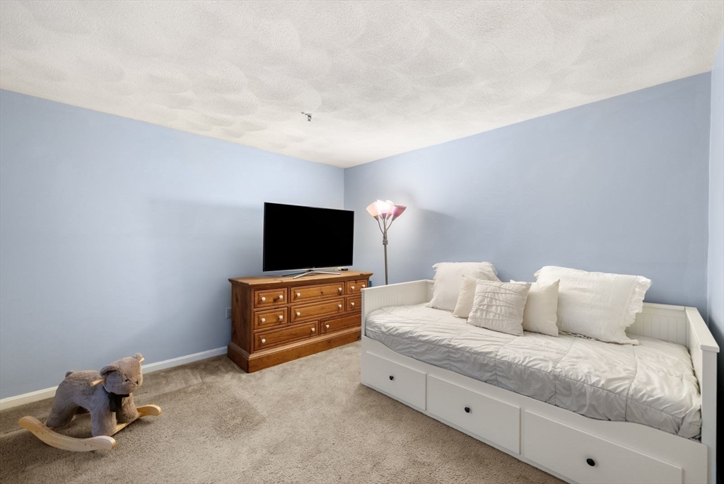 5 Oak Ridge Drive, Unit 7 Maynard, MA 01754 - Photo 13 of 20 a living room with furniture and a flat screen tv