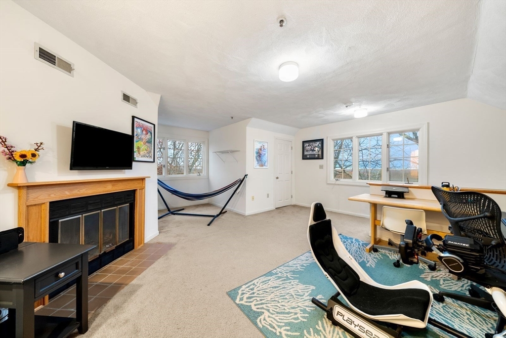 5 Oak Ridge Drive, Unit 7 Maynard, MA 01754 - Photo 14 of 20 a living room with furniture and a flat screen tv