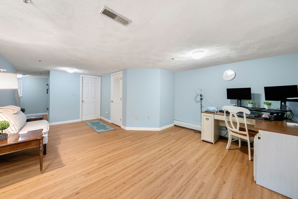 5 Oak Ridge Drive, Unit 7 Maynard, MA 01754 - Photo 17 of 20 a view of a livingroom with furniture and a flat screen tv