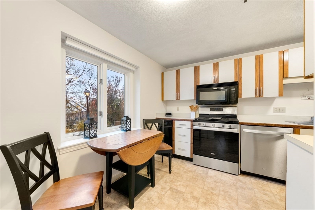 5 Oak Ridge Drive, Unit 7 Maynard, MA 01754 - Photo 8 of 20 a kitchen with a stove a sink and a refrigerator