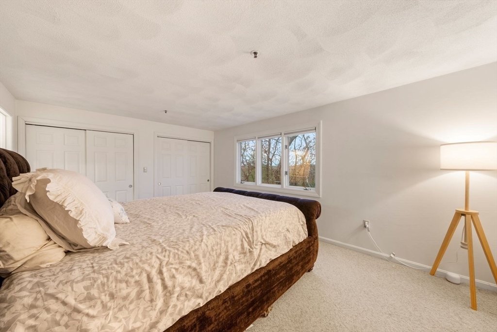 5 Oak Ridge Drive, Unit 7 Maynard, MA 01754 - Photo 10 of 20 a bedroom with a bed and a window