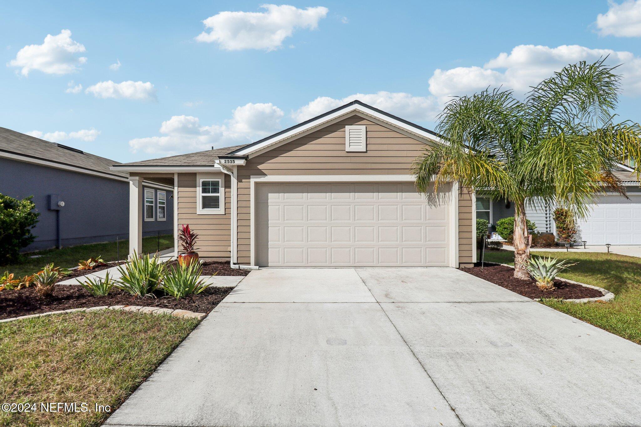 2535 Acorn Creek Road Green Cove Springs, FL 32043 - Photo 1 of 35 a front view of a house with garden