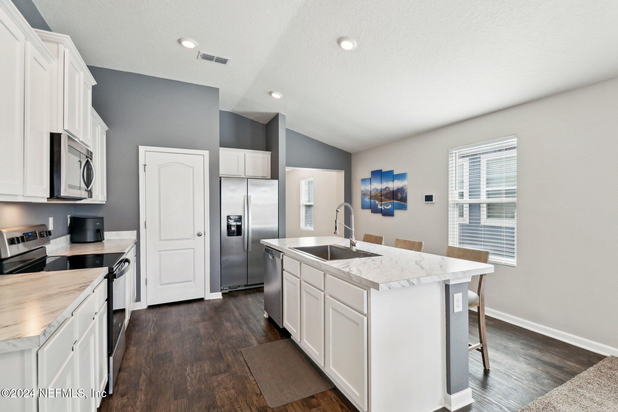 2535 Acorn Creek Road Green Cove Springs, FL 32043 - Photo 11 of 35 a kitchen with a stove a refrigerator and a sink